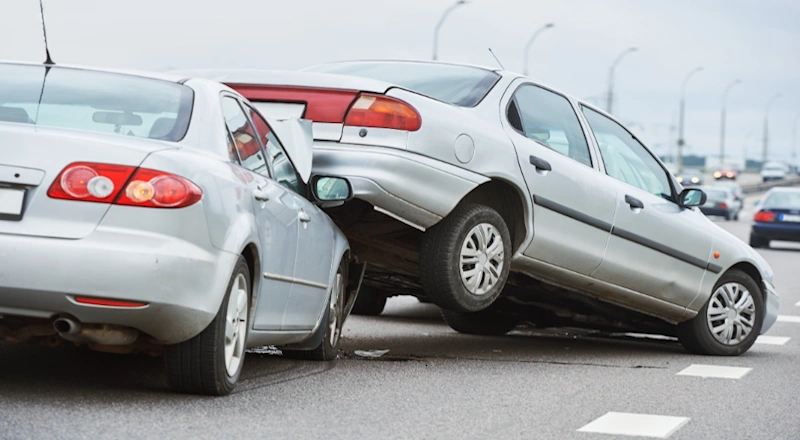 A collision between two silver cars on a busy road seeking Myrtle Beach auto accident attorney